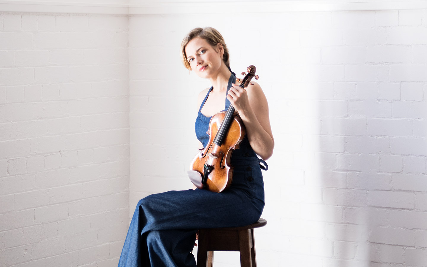 ACO Principal Violin Satu holding a Stradivarius violin