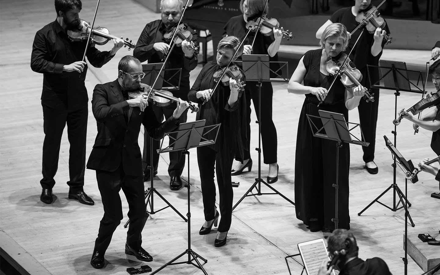 Richard Tognetti leading ACO musicians onstage.