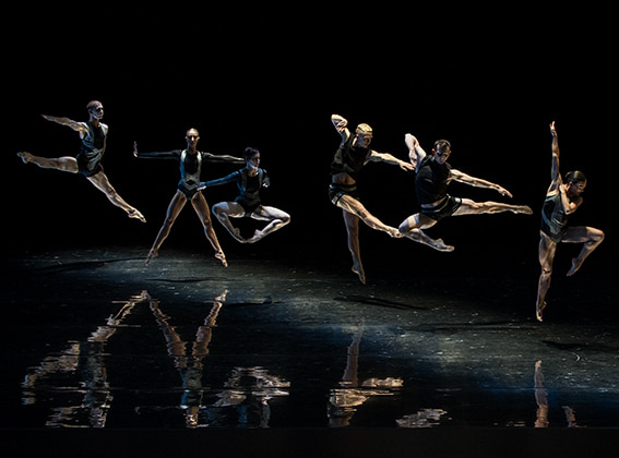 A still of Sydney Dance Company Dancers mid-air