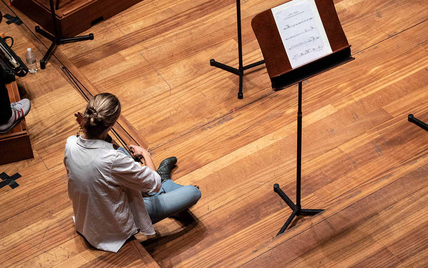 A photo from above of violist Nicole Divall regearsing