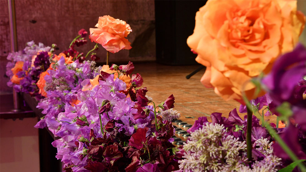 A POHO flower arrangement on a table at an ACO event