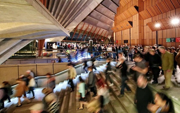 Audience members moving in a blur up and down the stairs at the Sydney Opera House